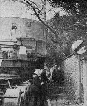 Photograph of a lorry's load entangled in an overhanging tree.