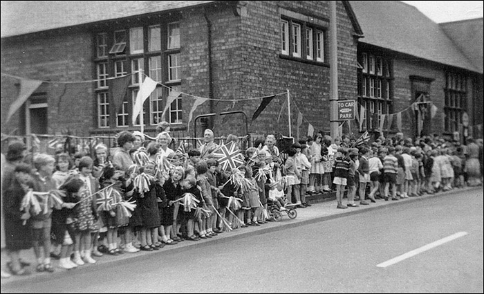 Children of Burton Latimer Council Schools await the drive-past of the Queen in July 1965