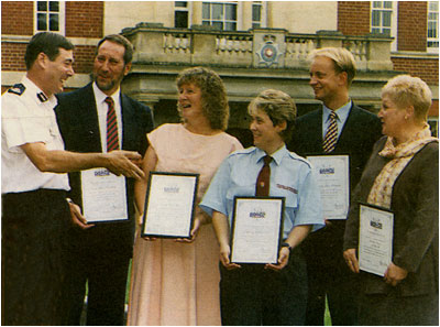Photograph showing award winners honoured by police with Pam Mills 3rd from left