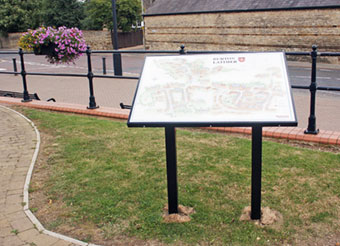 Photograph of the illustrated panel situated in Millennium Gardens close to the site of the former Denton's Farm at bottom of Churchill Way