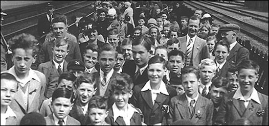 Photograph showing a joint school outing of pupils from the Church and the Council Schools  mid 1930s. Mr Fred Pentelow (deputy head of the Council School) and Mrs Pentelow are shown on the left and Mr Mitchell with Mr J Dunn of the Church School are on the right.