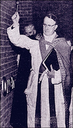Photograph showing Vicar General of Northampton, Mgr F Diamond, blessing the walls