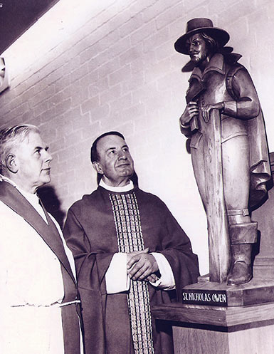 Photograph showing Father Donald Jenkinson and Mgr Frank Diamond admiring the new carved wooden figure of the martyr St Nicholas Owen