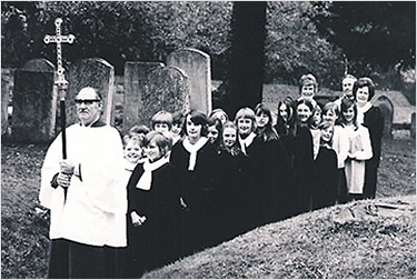 Photograph of the choir in 1975 processing through the churchyard