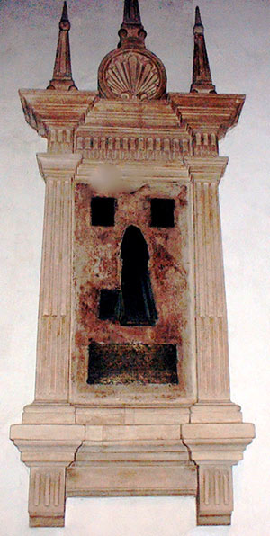 The Margaret Bacon brass within monument on south aisle wall.