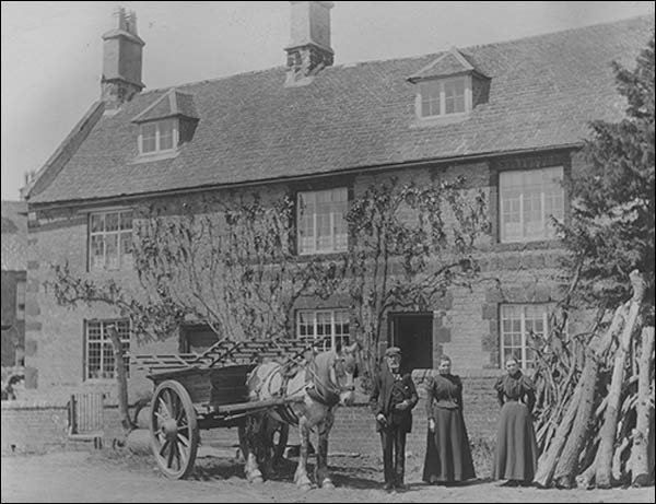 Mr Jesse Fox and family outside the farmhouse