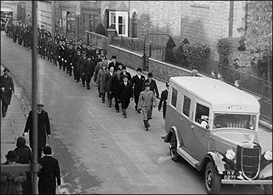 St John Ambulance Parade c1938 passing the Council School.  Mr Bob Phillips is seen on the left with a collecting tin indicating this to be a fund-raising event in aid of the Ambulance Fund.  Members of the Urban District Council are followed by the St John Ambulance Brigade.