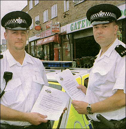 Photograph of police constables with letters for delivery to residents