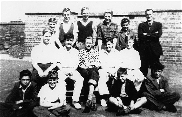 A group of boys with Mr Wetherall in the playground of Burton Latimer Council Junior School in about 1952