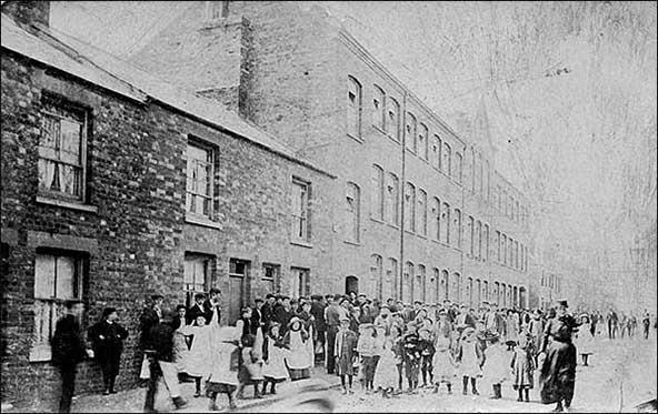 Local people gathered outside the factory before the extension was built