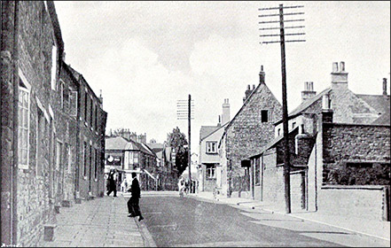 The High Causway in about 1950.  The man is using the two kerbs as a step.  The line of the houses also caused the pathway to get much wider in the central part of the terrace.