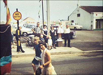 The annual parade passes the garage site