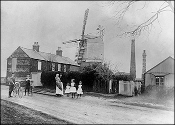 The north windmillin Burton Latimer in about 1906.  Hodson family in the foreground