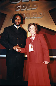 Pam Mills presented with the Gold Star by Lennox Lewis