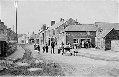 This photograph shows Harold's father standing in the doorway at the side of the family premises in the High Street, 1900.