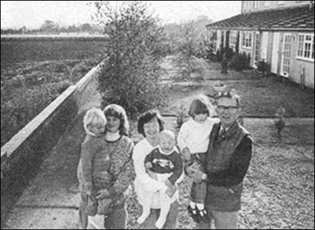 Photograph of protesting resisdents outside their homes at Windmill Cottages.