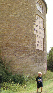 Photograph showing Andrew Corney, youngest son of the family outside the tower