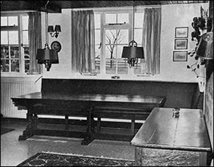 The table beneath the kitchen window with suspended lamps