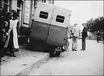 Photograph showing the St John Ambulance Brigade's ambulance in 1938 outside The Red Cow having mounted the pavement after brake failure.