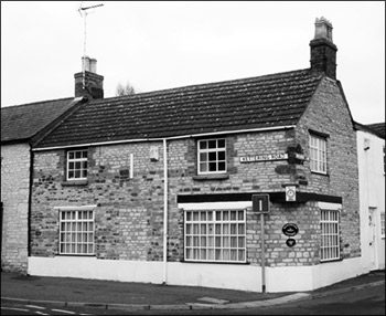 The former shop on the corner of Kettering Road and Bakehouse Lane, still showing the evidence of its previous use.