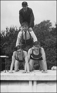 Three boys enjoy themselves by the pool