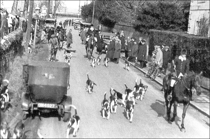 The start of a day's hunting in Kettering Road, watched by a good crowd.