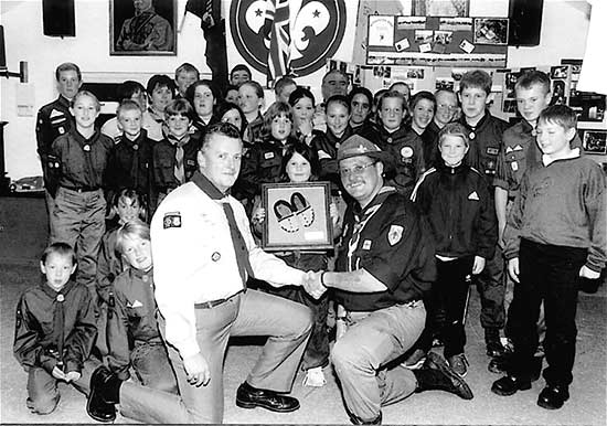 The Mohawk Troop showing off a pair of Indian Moccasins given to them as a sign of friendship by German Scouts at the international camp.  Left - ASL Adrian Watts, Right - GSL Bob Peden