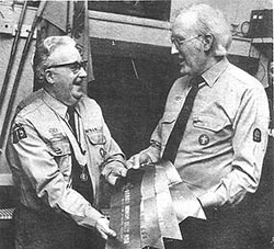 First Burton Latimer Scouts leader, Ray Chester, receiving the pennants from the Group Adviser, Jack Addis