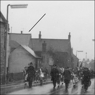 A 1950s remebrance Day parade passes 149 High Street and the old Band Club