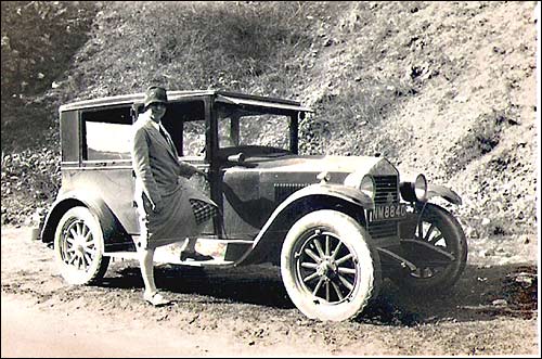 Photograph of a later Gilliatt Taxi with Florence Clipson (later Smith) standing on the running board