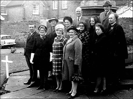 At the War Memorial after the 1973 Service of Remembrance. Standing at the back Arthur Knibbs and ? Second row: Mrs Nicholson, Mrs Joyce, Mrs Parfitt, Helen Featherstone, Margaret Heels, Revd Derek Taylor (Chaplain) Front row: Dennis Crick, Gwen Twelvetree, Josie Crick and Mrs Beach