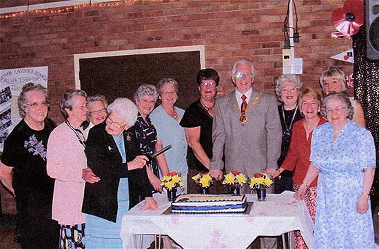 Cutting the cake at the celebration by Vice President Gwen Twelvetree and Councillor Derek Zanger